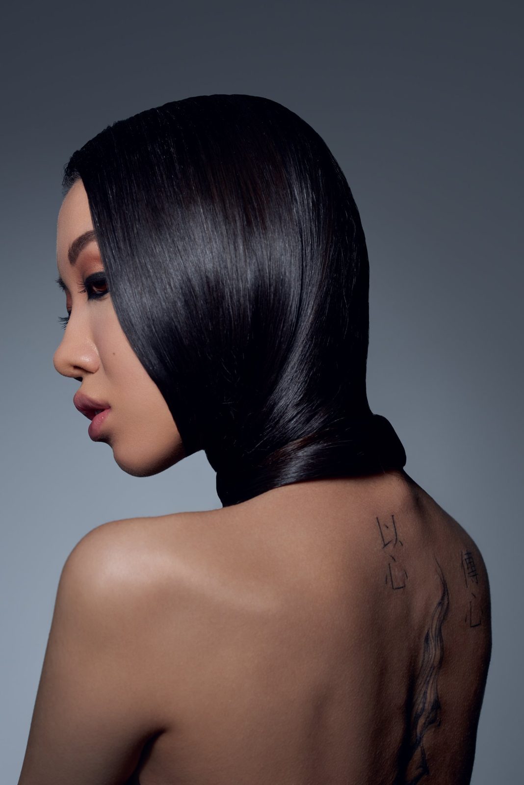 Profile from behind: sleek hair wrapped around the neck